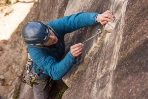 Trad climber placing gear